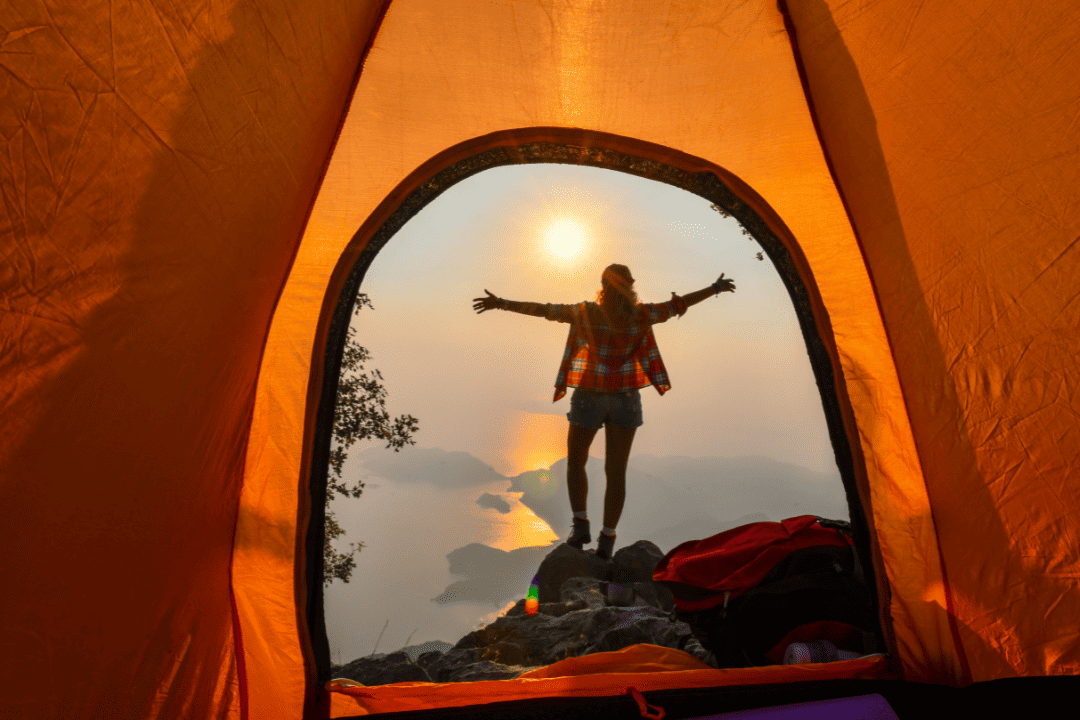 happy lady outside a tent