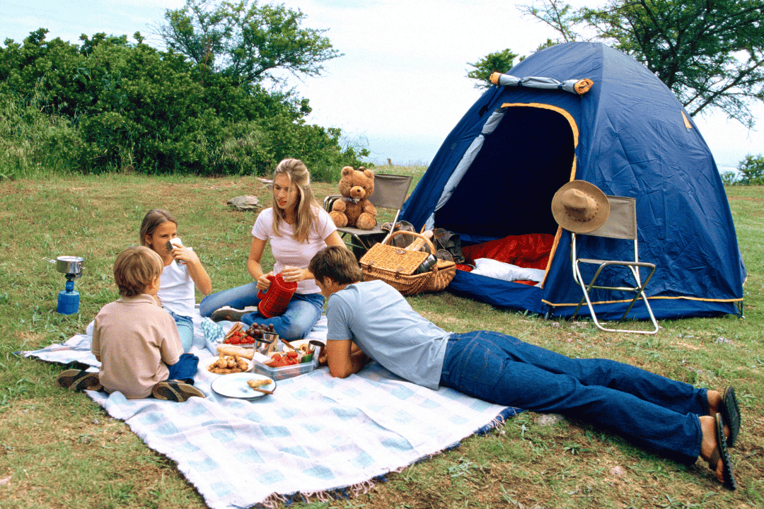 Family eating lunch while camping