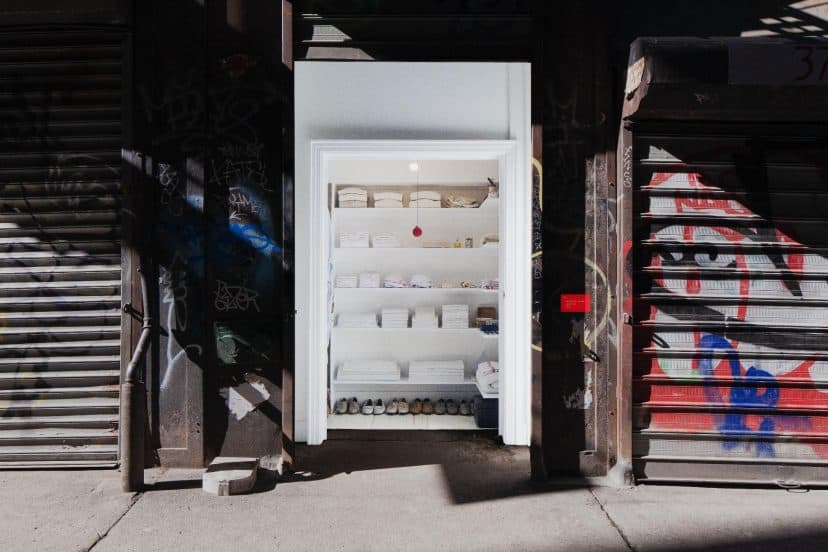 File:Sara Berman's Closet, Mmuseumm.png - a refrigerator is open in a garage with graffiti on the wa